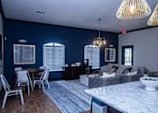 Thumbnail 3 of 14 - A modern kitchen with a dining table and chairs.