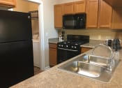 Thumbnail 37 of 39 - Model Kitchen at Remington Apartment Homes, Romeoville, 60446