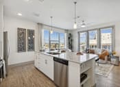 Thumbnail 10 of 27 - A modern kitchen with a large island and stainless steel appliances.