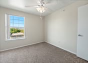 Thumbnail 10 of 13 - a bedroom with a ceiling fan and a window  at Collective on Riverside, Austin, 78741