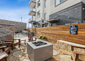 Thumbnail 14 of 27 - Private outdoor terrace with stone accent wall and wood fence