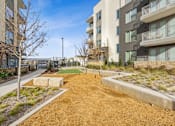 Thumbnail 15 of 27 - Apartment community exterior with walking path and landscaped grounds