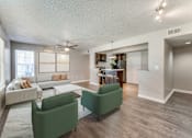 Thumbnail 3 of 27 - a living room with couches and chairs and a dining room with a kitchen  at Vibe on Riverside, Austin, TX