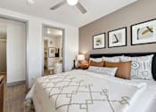 Thumbnail 9 of 27 - Apartment bedroom with ceiling fan, patterned bedding and neutral decor