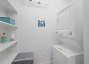 Thumbnail 23 of 32 - A laundry room with a washer and dryer.