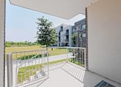 Thumbnail 17 of 32 - A balcony with a white railing and a white wall.