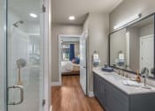 Thumbnail 10 of 26 - a bathroom with a large mirror and a glass shower  at Presidium Revelstoke, Fort Worth, TX, 76131