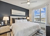 Thumbnail 3 of 27 - Spacious apartment bedroom with dark accent wall and floor-to-ceiling windows