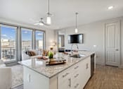 Thumbnail 7 of 27 - Kitchen island with white quartz countertop and modern pendant lighting