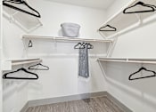 Thumbnail 25 of 27 - Walk-in closet with dual hanging rods and open shelving system