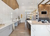 Thumbnail 27 of 27 - Bright open interior with white shiplap walls, marble countertops and modern pendant lighting