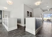 Thumbnail 21 of 27 - A spacious lobby with a white reception desk and grey tiled flooring