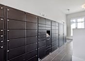 Thumbnail 23 of 27 - A row of black lockers are lined up in a room.