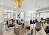 Thumbnail 26 of 27 - Elegant resident lounge with statement chandelier, dark wood flooring and curated seating