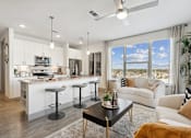 Thumbnail 2 of 27 - A modern kitchen with white cabinets and a bar area.