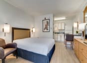 Thumbnail 4 of 8 - a hotel room with a bed and a kitchen  at Waterford Studios, Texas