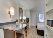 Thumbnail 1 of 8 - a living room with a kitchen and a bedroom with a bed  at Waterford Studios, Texas, 78758