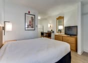 Thumbnail 5 of 8 - a bedroom with a bed and a tv in a hotel room  at Waterford Studios, Austin, Texas