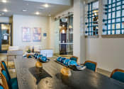 Thumbnail 8 of 45 - A long wooden table with blue and white plates on it.