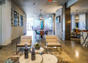 Thumbnail 9 of 45 - A cozy room with two white chairs and a coffee table in front on them