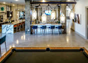 Thumbnail 23 of 45 - A pool table is in the foreground of this image.