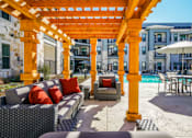 Thumbnail 6 of 45 - A patio with a yellow pergola and a pool table, Manor, TX