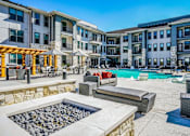 Thumbnail 8 of 27 - A sunny day at a resort with a pool and a hot tub at The Grand at Manor Apartments, Manor, TX