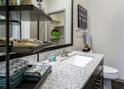 Thumbnail 42 of 45 - A bathroom with a white sink and a mirror above it.