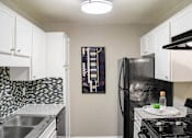 Thumbnail 4 of 27 - Fully Equipped Kitchen Includes Frost-Free Refrigerator, Electric Range, & Dishwasher at The Entro at Midtown, Dallas, TX
