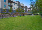Thumbnail 22 of 26 - a grassy area with a fire hydrant and apartment buildings in the background  at Presidium Revelstoke, Fort Worth, 76131