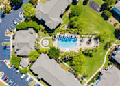 Thumbnail 11 of 23 - A bird's eye view of a neighborhood with a pool and a playground.