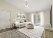 Thumbnail 19 of 24 - a living room with a white couch and a ceiling fan at Baldwin Farms Apartments, Robertsdale