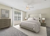 Thumbnail 22 of 24 - a bedroom with a bed and a ceiling fan at Baldwin Farms Apartments, Alabama