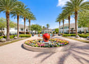 Thumbnail 17 of 23 - A large red sculpture is the centerpiece of a landscaped garden.