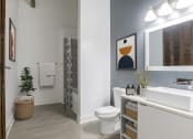 Thumbnail 22 of 46 - a bathroom with a toilet and a sink and a mirror at The Mobile Lofts, Mobile, 36604