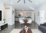 Thumbnail 27 of 46 - a living room and kitchen with a table and chairs at The Mobile Lofts, Alabama