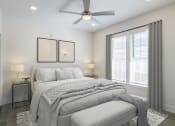 Thumbnail 28 of 46 - a white bedroom with a large bed and a ceiling fan at The Mobile Lofts, Mobile, AL