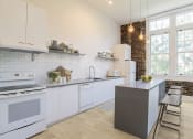 Thumbnail 41 of 46 - a white kitchen with white appliances and a counter topat The Mobile Lofts, Mobile, AL, 36604