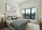 Thumbnail 2 of 7 - a bedroom with a bed and a large window at The Mobile Lofts, Alabama