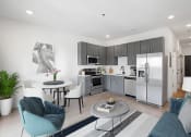 Thumbnail 7 of 7 - a kitchen and living room with stainless steel appliances and a table at The Mobile Lofts, Alabama