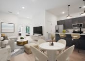 Thumbnail 6 of 7 - an open living room and kitchen with a table and chairs at The Mobile Lofts, Alabama