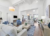 Thumbnail 7 of 23 - A spacious living room with a grey sofa and a white couch.