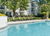 Thumbnail 18 of 32 - a swimming pool in front of an apartment building at Dothan Farms, Dothan