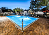 Thumbnail 1 of 25 - a swimming pool with blue water in a resort style pool at Ashton Oaks, New Port Richey, Florida