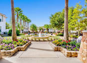Thumbnail 16 of 23 - A beautifully landscaped garden with a fountain at its center.