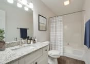 Thumbnail 27 of 32 - a bathroom with a sink and a toilet next to a bathtub at Dothan Farms, Dothan, AL