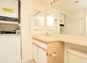Thumbnail 9 of 9 - a bathroom with a sink and a mirror and a refrigerator