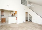 Thumbnail 4 of 9 - an empty living room with white walls and a ceiling fan