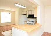 Thumbnail 6 of 9 - a kitchen with a sink and a stove and a refrigerator
