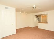 Thumbnail 7 of 9 - an empty living room with a ceiling fan